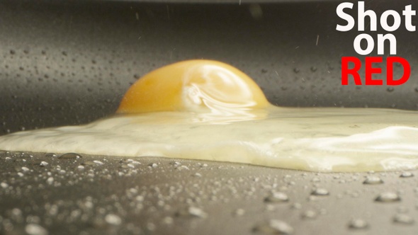 Cooking Egg On A Frying Pan A Macro Shot On Red Camera alt