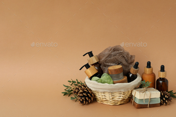 Concept of gift with basket of cosmetics on beige background