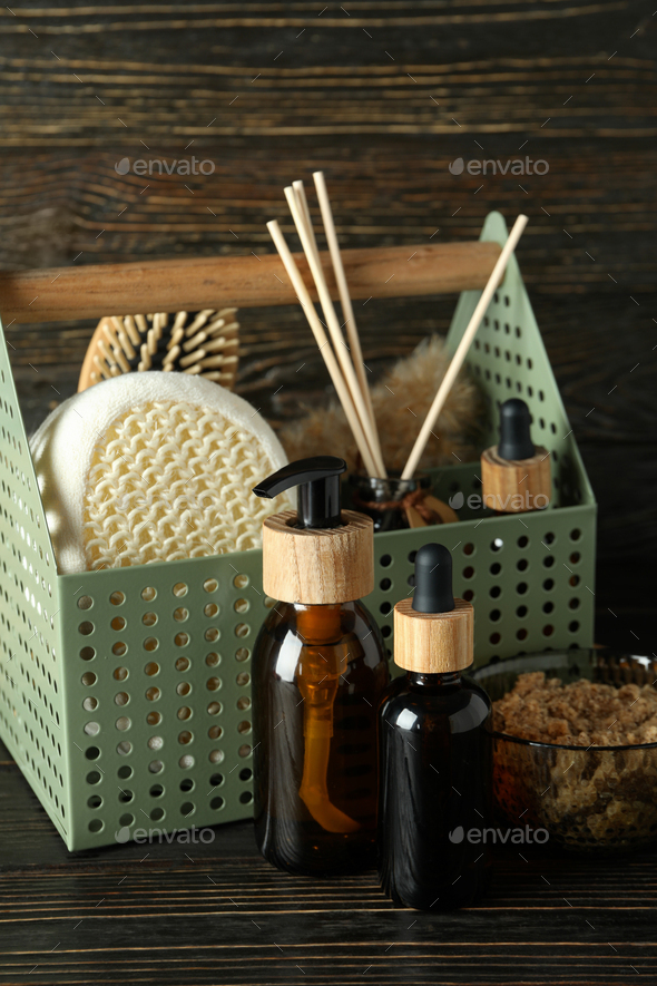 Concept of gift with basket of cosmetics on wooden background