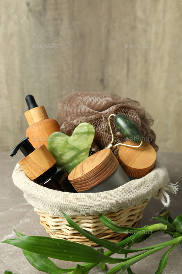 Concept of gift with basket of cosmetics on textured table