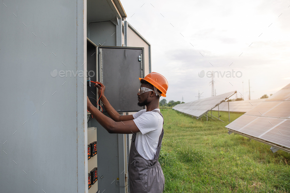 African electrician doing service work on solar station