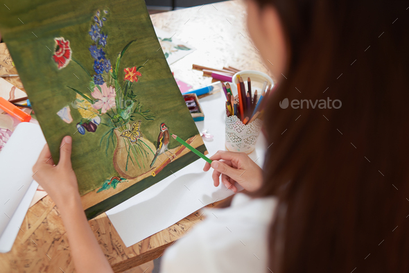 Painte holding pencil and picture of lovely flowers