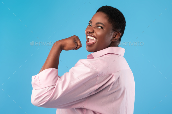 Happy Black Lady Showing Biceps Gesturing Yes On Blue Background