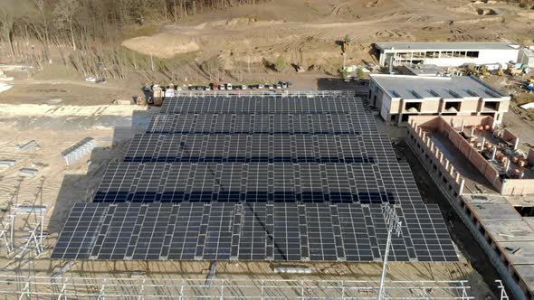 Aerial Circling View of Construction of a Solar Power Plant and Installation of Solar Panels alt