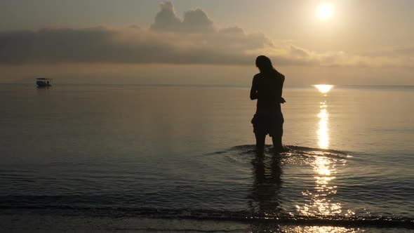 Young Man on a Paradise Beach at Dawn