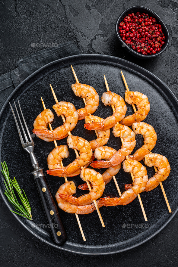 BBQ Grilled shrimps prawns on skewers with spices, herbs. Black
