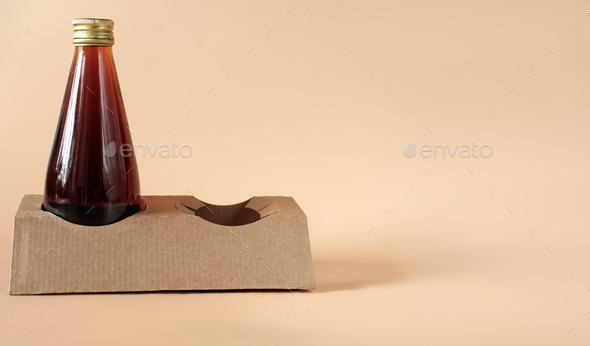 cold brew coffee in glass bottle. Coffee to go concept. carton or paper biodegradable holder