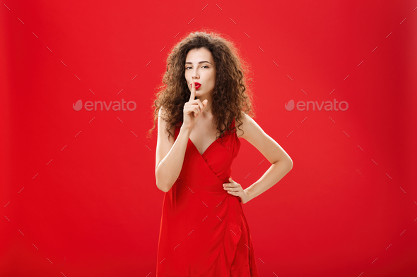 Shh let us keep it between us. Attractive and elegant adult successful woman in stylish evening