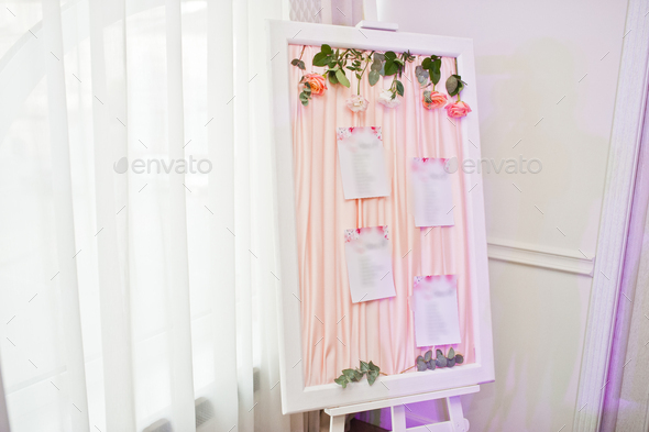 Beautiful wedding set decoration in the restaurant. Board with guest list