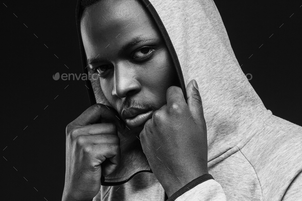 Portrait of bad guy with thug life, weating hoodie, looking at camera