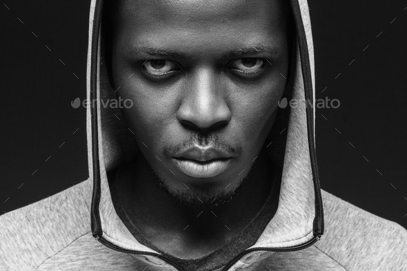 African criminal concept, portrait of bad guy with thug life, weating hoodie