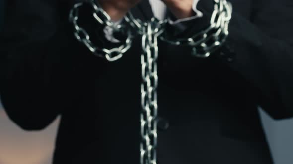 Man Dressed in Jacket with Chained Hands alt