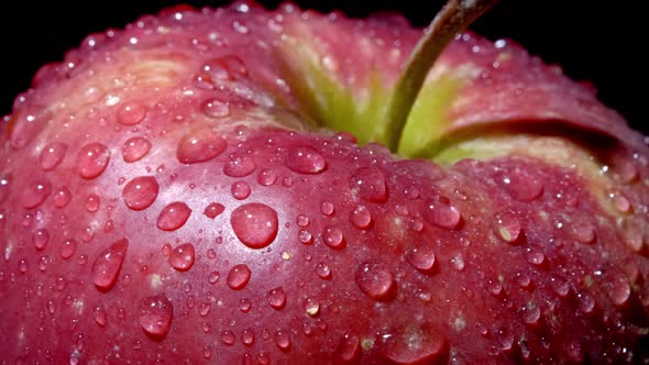Close-up of a Red-green Apple with Water Droplets Macro Shot. The Apple Rotates Around Its Axis on a alt
