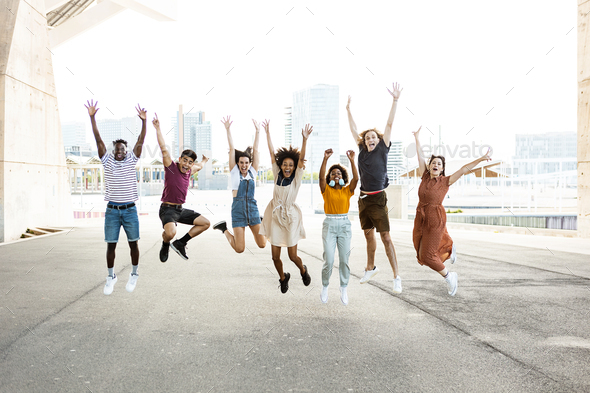 Happy multiracial people jumping together outdoors - Stock Photo - Images
