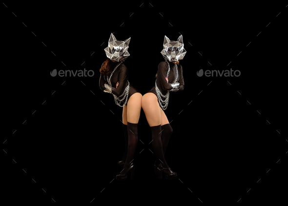 Two go-go variety show dancers in wolf masks on black