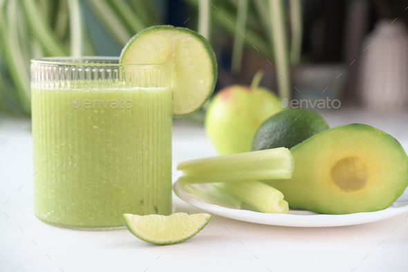 Detox diet. Green smoothie with fruits and vegetables on white table. Stock  Photo by Yulia_Panova