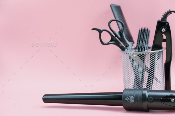 hair stylist tools in a basket. scissors, brush, comb. curling iron,