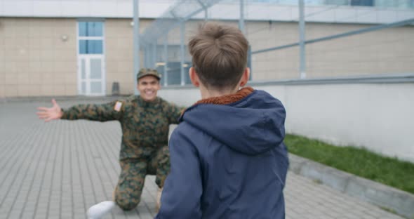 Son Running To Millitary Father. alt