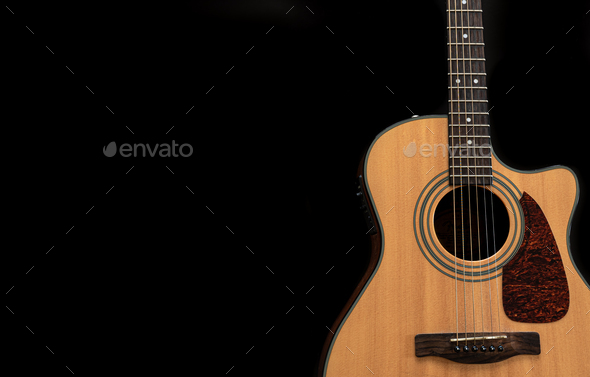 Acoustic guitar on a black background, flat lay, copy space. Stock Photo by  puhimec