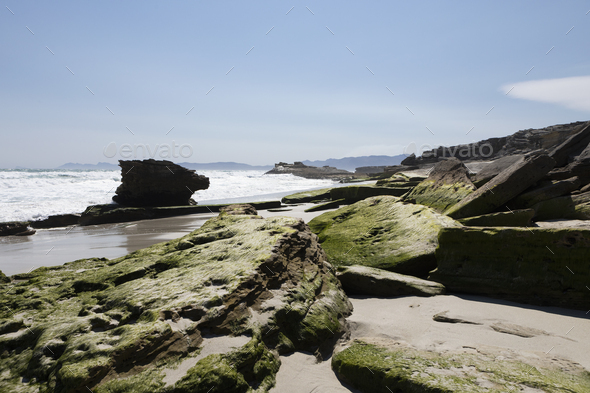 The Walker Bay Nature Reserve coastline with weathered rock pillars and smooth flat rocks. - Stock Photo - Images