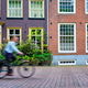 Bicycle rider cyclist man on bicycle very popular means of transoirt in Netherlands in street of - PhotoDune Item for Sale