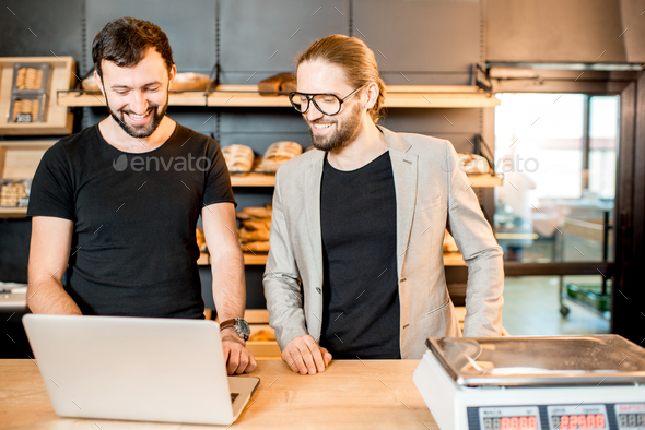 Businessmen working with laptop at the bakery shop