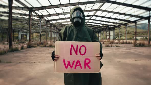Ukrainian Boy Holding an No War Placard in His Hand alt