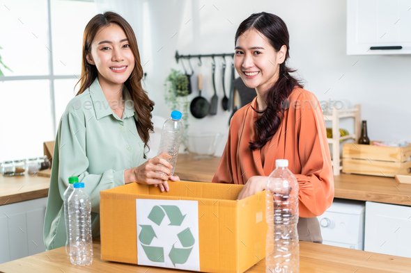 Portrait of Asian women hold trash bin for further recycling at home. Zero waste concept.
