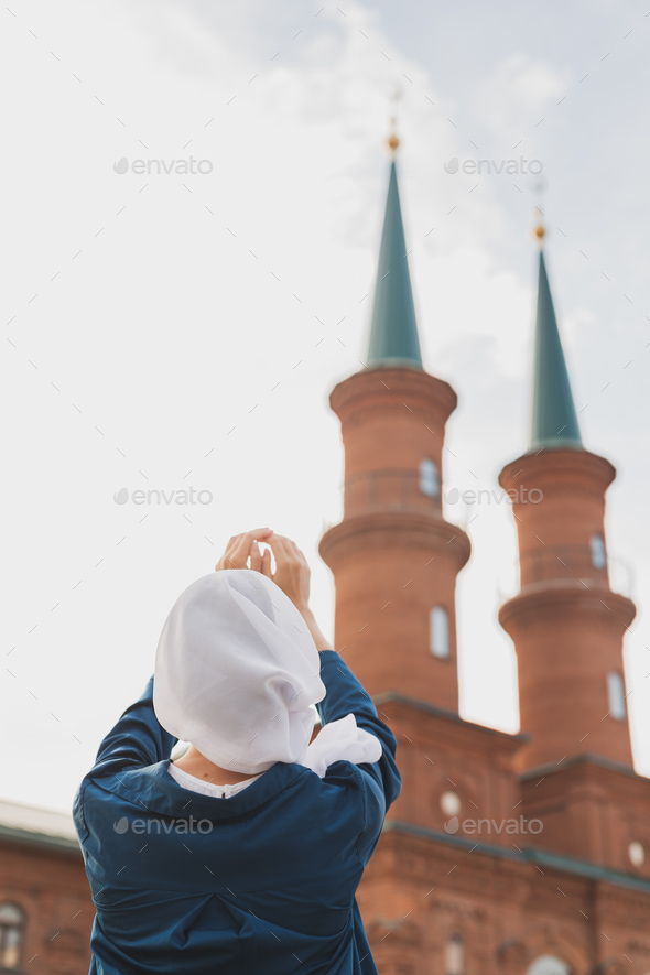 Muslim woman prayer wear hijab fasting pray to allah on mosque background