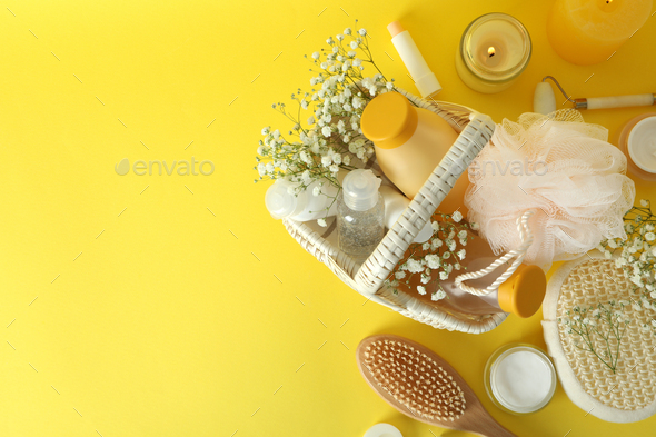 Concept of gift with basket of cosmetics on yellow background
