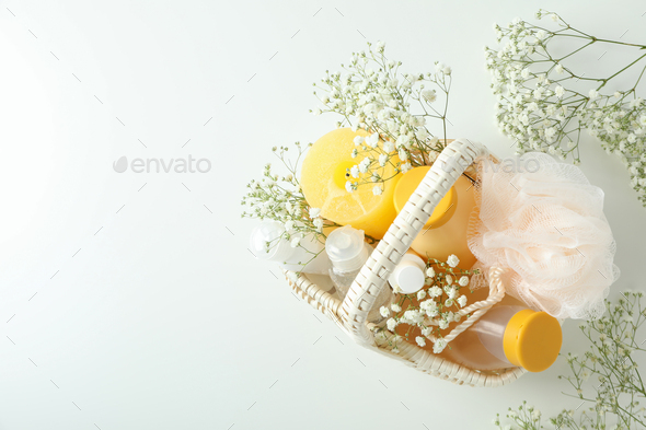 Concept of gift with basket of cosmetics on white background