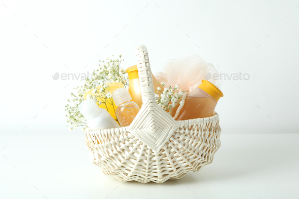 Gift basket with cosmetics on white table
