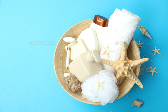 Concept of gift with basket of cosmetics on blue background