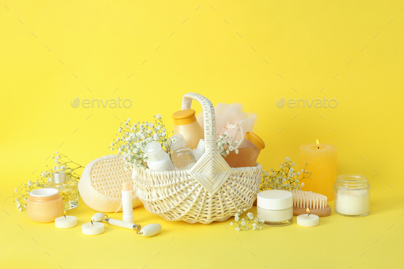 Concept of gift with basket of cosmetics on yellow background