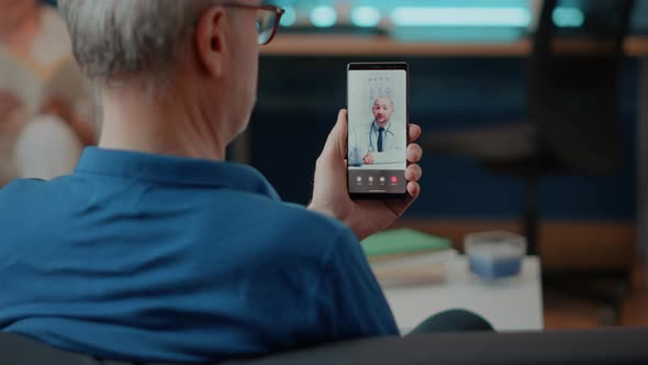 Elderly Person Calling Doctor on Videoconference to Attend Consultation alt
