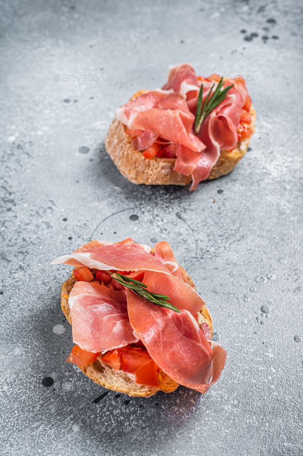 Spanish Tapas with tomatoes and cured Slices of jamon iberico ham