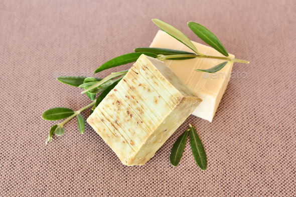 Handmade soap bars and olive branches on fabric background - Stock Photo - Images