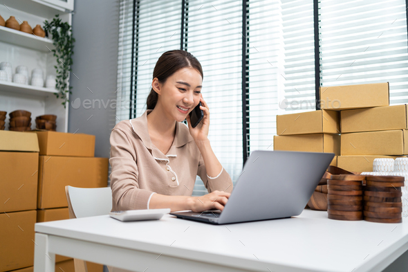 Asian beautiful woman sell vase product and check sale order on laptop.