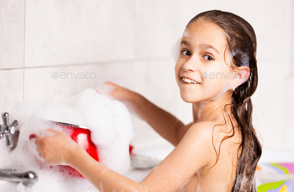 Cheerful Little Caucasian Girl Plays With Foam While Bathing In The