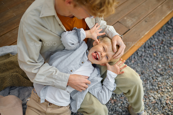 Father and son poses on camera, summer camping - Stock Photo - Images