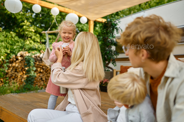 Cheerful family resting at the motorhome, camping - Stock Photo - Images