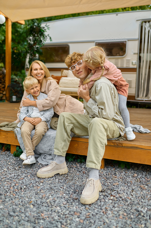 Happy family poses at the trailer, summer camping - Stock Photo - Images