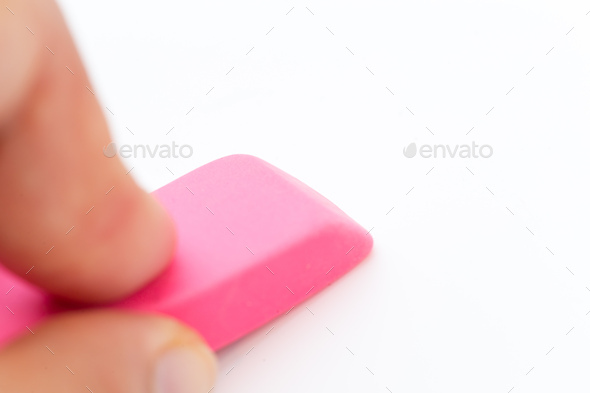 eraser tool in a hand isolated on white background. school and office tool