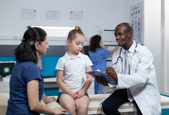 African american pediatrician doctor writing disease expertise of child ...