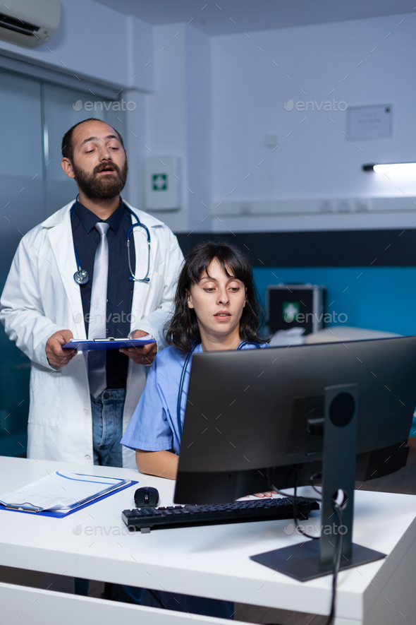 Doctor and nurse working with technology on computer
