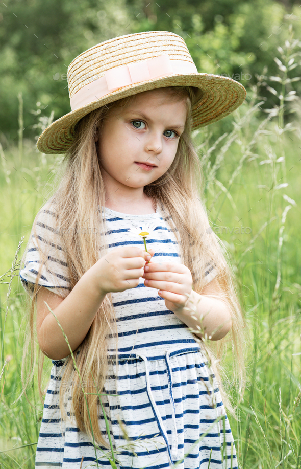 Cute little girl in a field Stock Photo by Olena_Rudo | PhotoDune