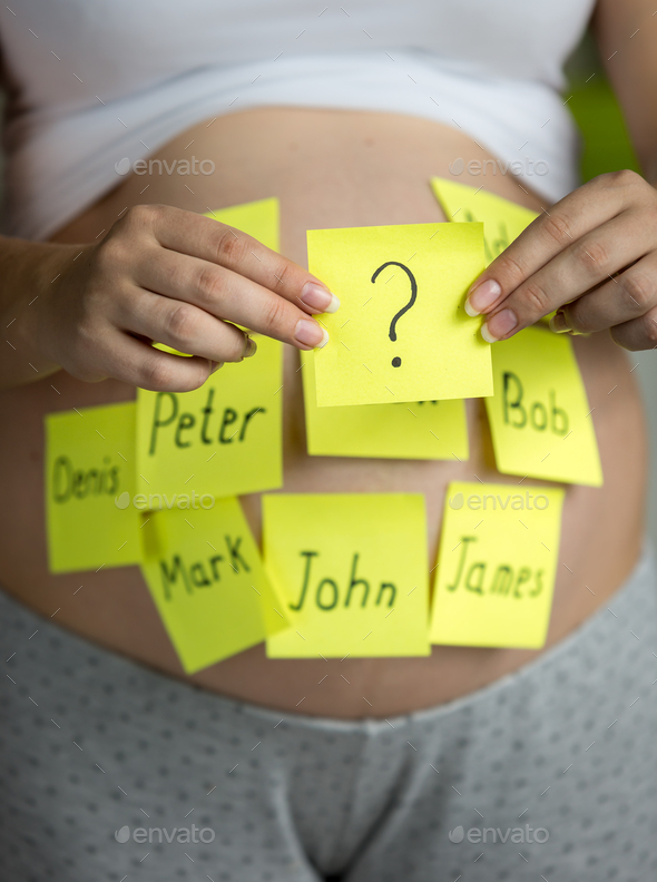 photo of pregnant woman choosing future baby name - Stock Photo - Images