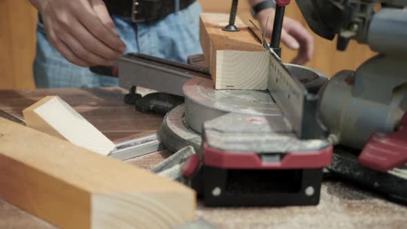 Sawing a Wooden Block with a Cutting Saw in a Carpentry Workshop ...