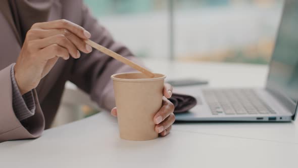 Closeup Unrecognizable Businesswoman Sitting at Work at Office Desk with Laptop Female Hands Mixing