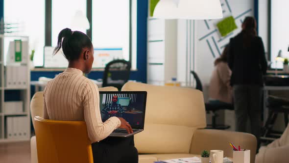 Black Woman Discussing with Remote Disabled Colleague Using Video Call alt